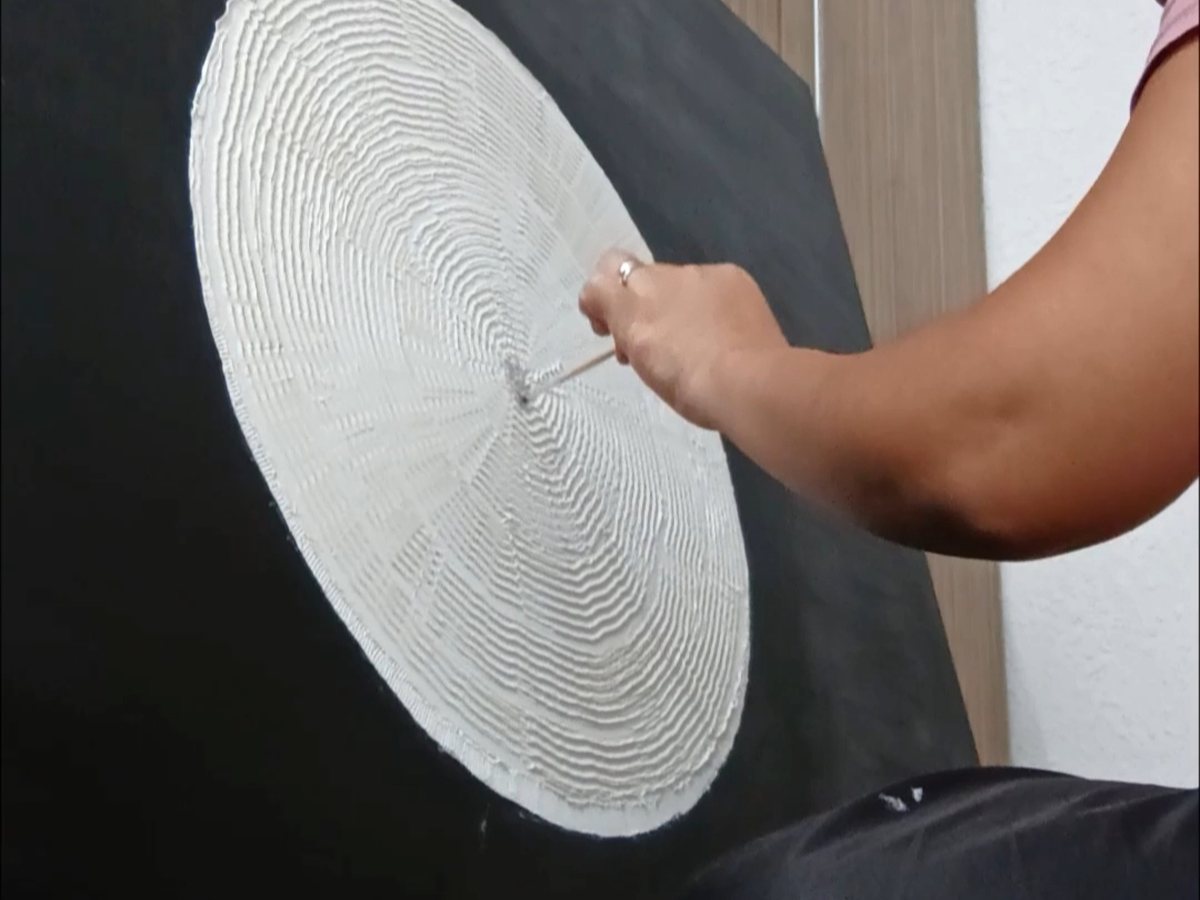 Applying texture paste by hand, building the relief ring by ring